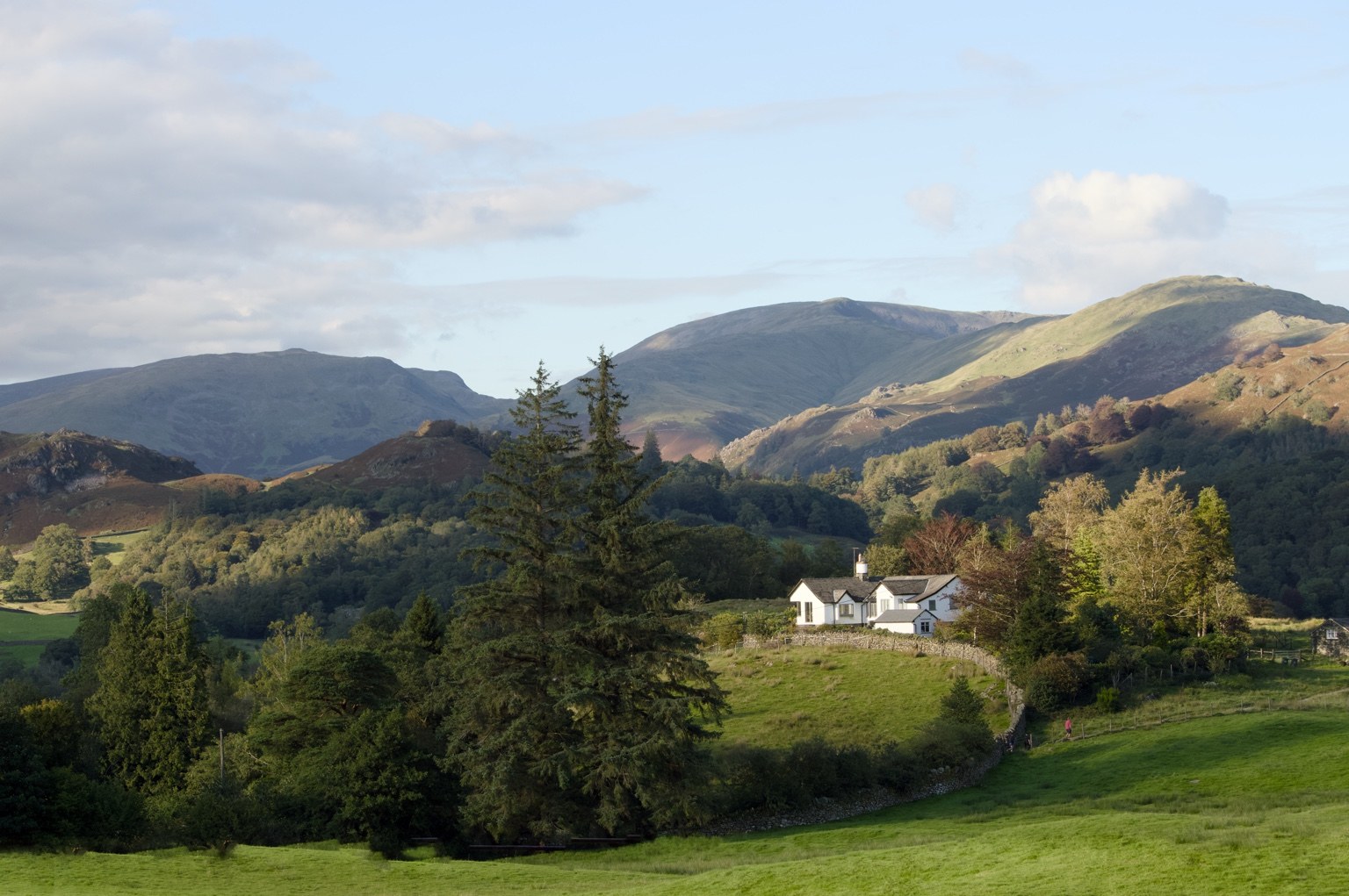 Cumbrian house and fells landscape photograph available as a professional print